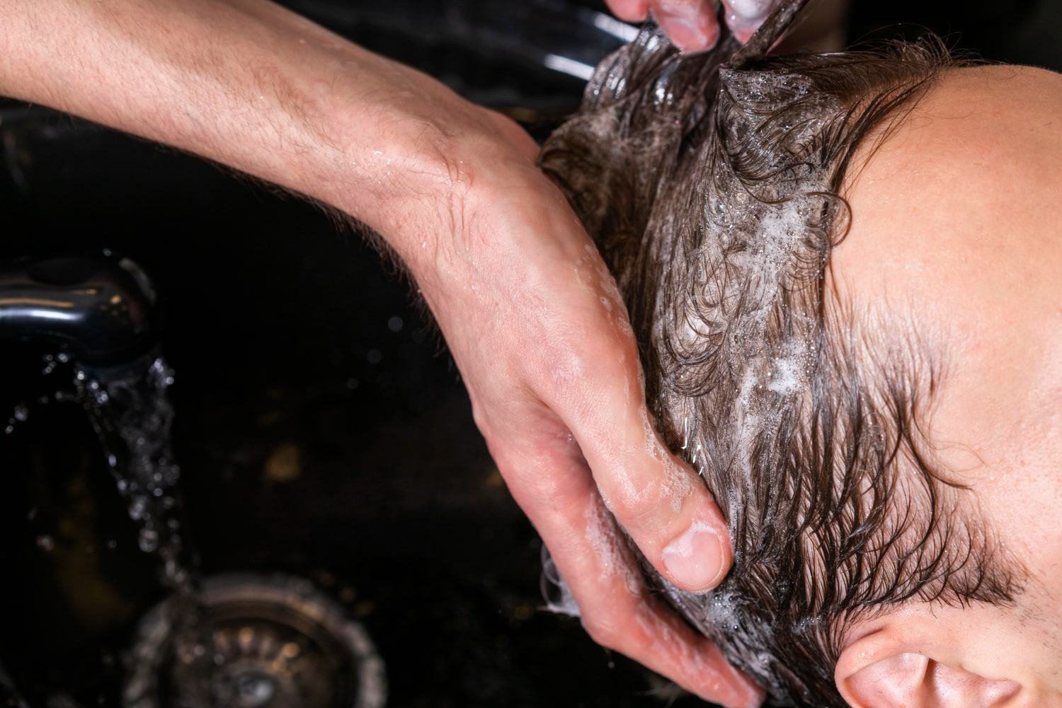 man-washing-client-s-hair